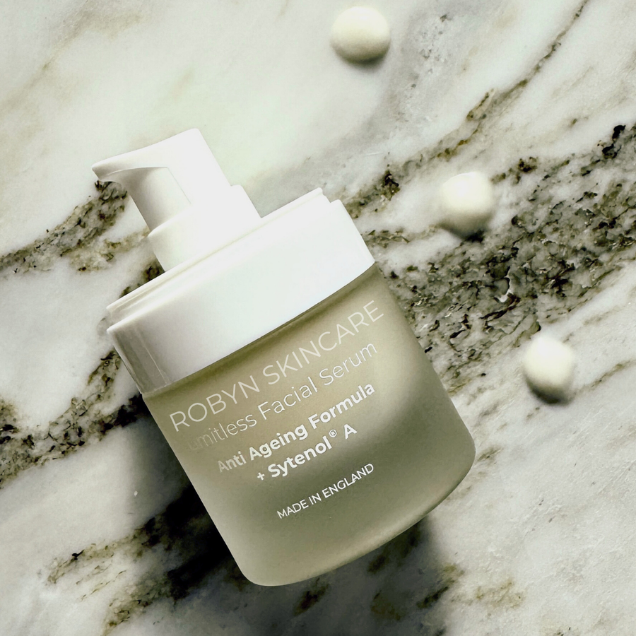 Robyn Skincare Hyaluronic Hydration Serum surrounded by serum  droplets on smooth marble – deep moisture and skin plumping formula