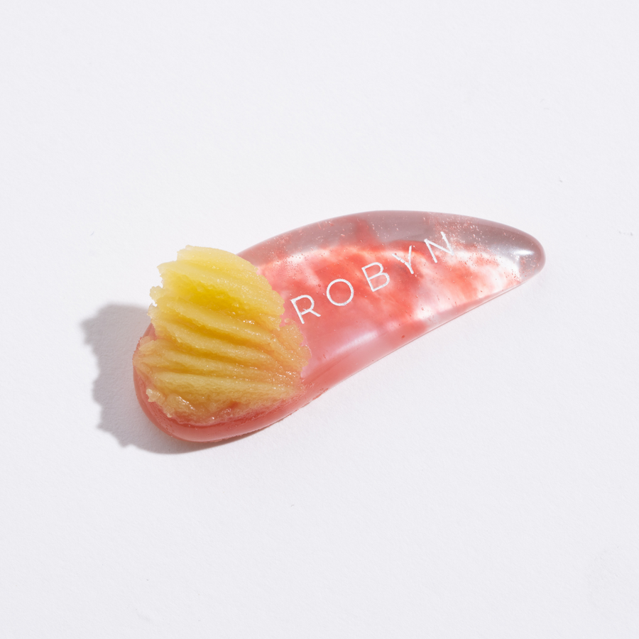 Rich creamy night balm texture with Bakuchiol, acai oil and cupuaçu butter on rose quartz spatula